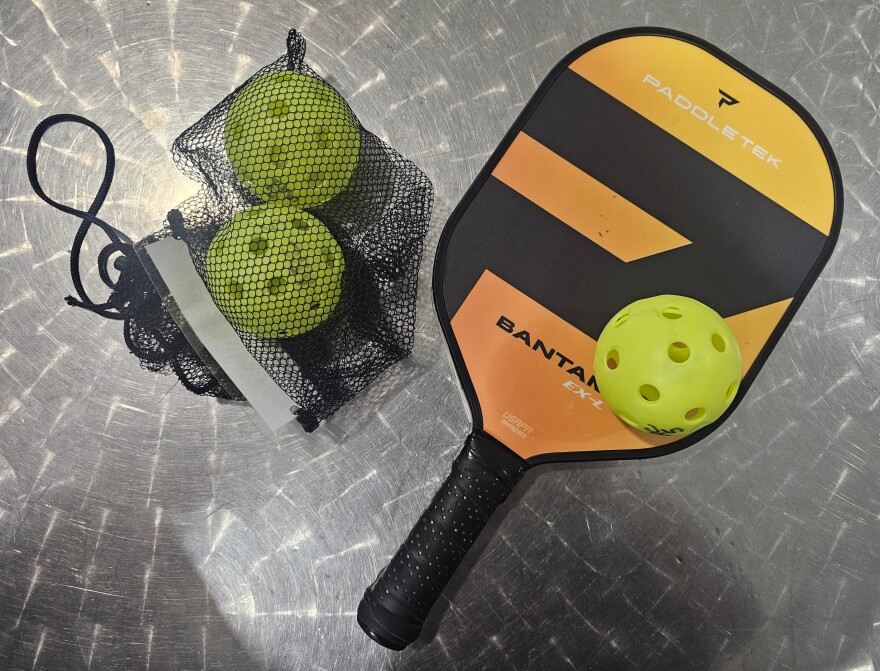 Pickleball paddle, balls, and practice equipment